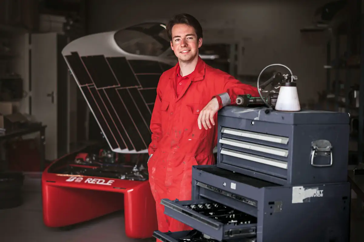 A shop owner standing by his tool chest in the garage