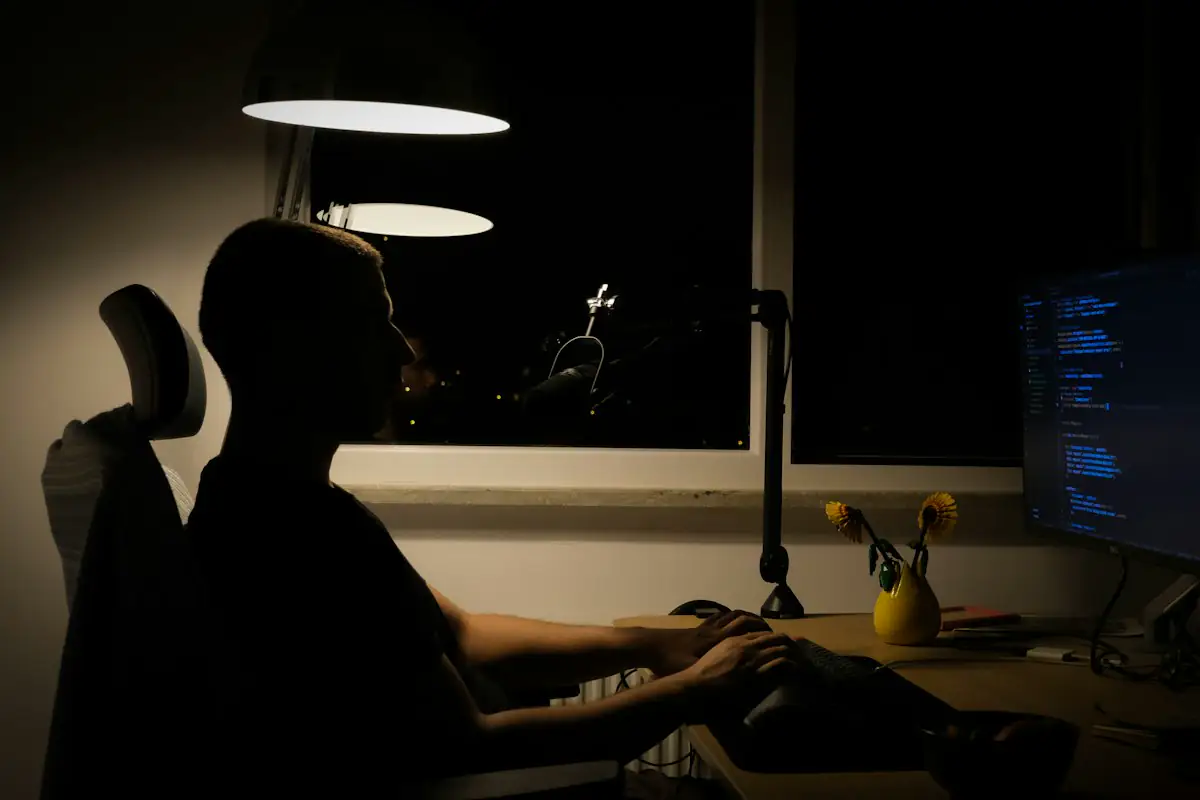 Someone working alone at a computer late at night