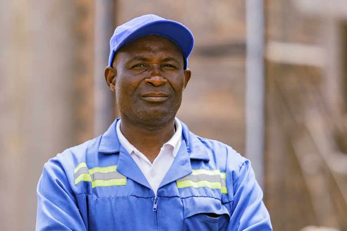 A contractor in work uniform looking at the camera